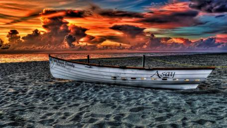 Serene Sunset with Beached Boat wallpaper
