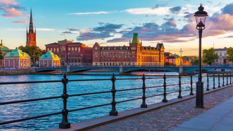 Serene Stockholm Sunset Over the River wallpaper