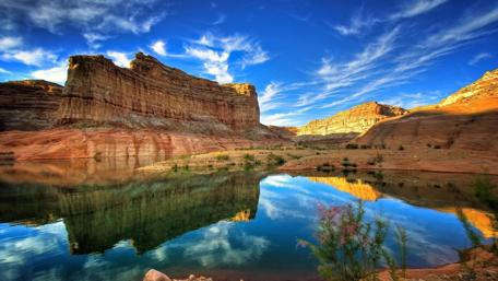 Mirrored Rocky Landscape Under Blue Sky wallpaper