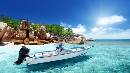 Serenity by the Shore with a Motorboat wallpaper