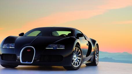 Sleek Black Beauty Against a Sunset Horizon wallpaper
