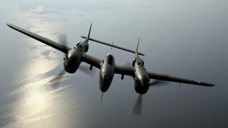 Legendary P-38 Lightning in Flight Over Water wallpaper