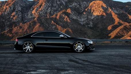 Sleek Black Audi on Mountain Road wallpaper