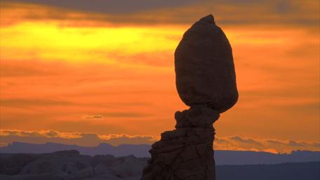 Serene Sunset Over Majestic Rock Formation wallpaper