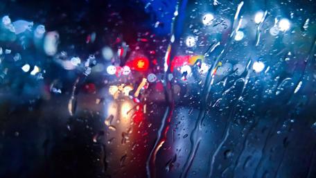 Rainy City Lights Through Glass wallpaper