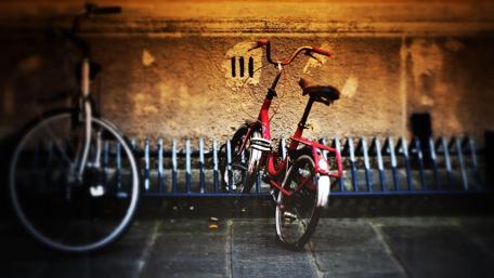 Vibrant Red Bicycle Against Stone Wall wallpaper