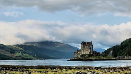Majestic Scottish Castle by the Serene Waters wallpaper