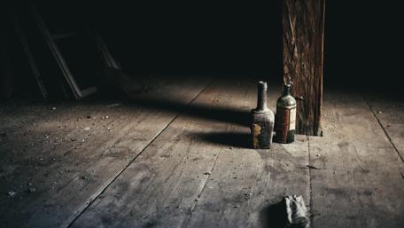 Urban Abandonment with Vintage Bottles in Dim Light wallpaper