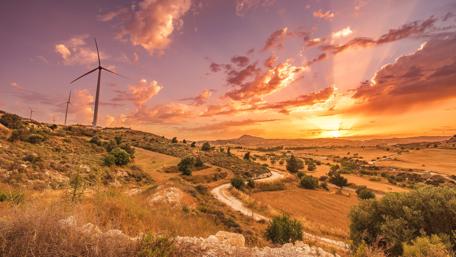 Serene Sunset Over Windmill Fields wallpaper
