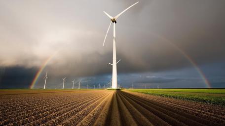 Majestic Windmills Beneath a Vibrant Rainbow wallpaper