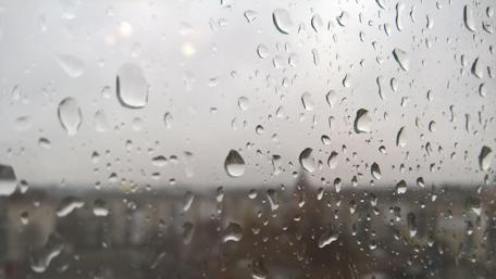 Rainy Cityscape Through Glass wallpaper