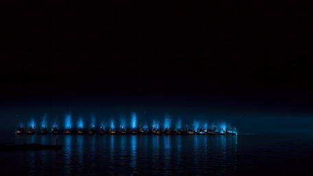Serene Night Boats Illuminated by Blue Glow wallpaper
