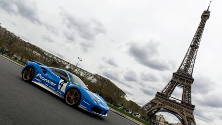 Dynamic Ferrari Racing Through Paris Streets wallpaper