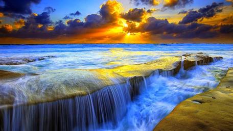 Sunset Cascade at the Ocean's Edge wallpaper