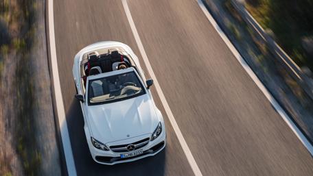 Sleek Luxury Convertible on Open Road wallpaper