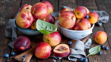Fresh Summer Fruits in Rustic Bowls wallpaper