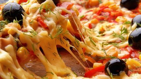 Delicious Cheese Pizza with Olives and Fresh Vegetables wallpaper