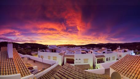 Ibiza's Golden Dusk Over Rooftops wallpaper