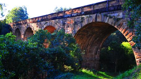 Ancient Viaduct Embraced by Nature in 4K Quality wallpaper