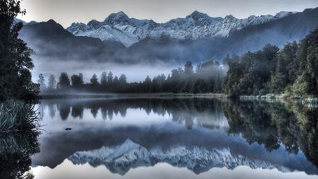 Misty Mountain Reflections on a Tranquil Lake wallpaper