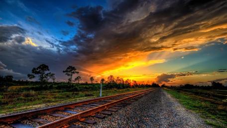 Endless Tracks Under a Vibrant Sunset wallpaper