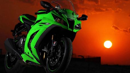 Vibrant Green Motorbike Against Sunset Sky wallpaper
