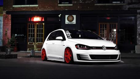 Sleek Volkswagen Golf with Bold Red Wheels Showcase wallpaper