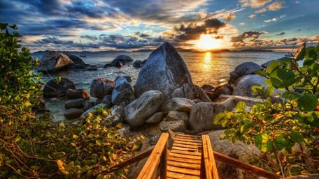 Serene Caribbean Sunrise Over Coastal Stones wallpaper