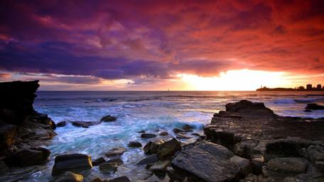 Majestic Sunset Over Rocky Shoreline wallpaper
