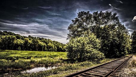 Tranquil Train Tracks Amidst Nature's Beauty wallpaper