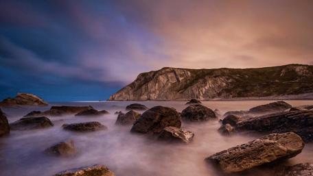 Serene Twilight Over Misty Sea Rocks wallpaper