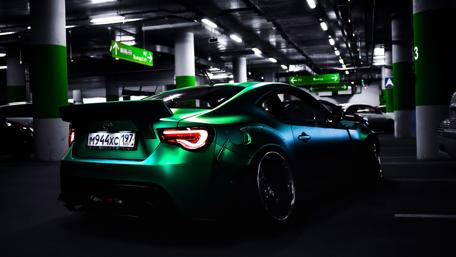 Sleek Toyota Supra in Neon-lit Parking wallpaper