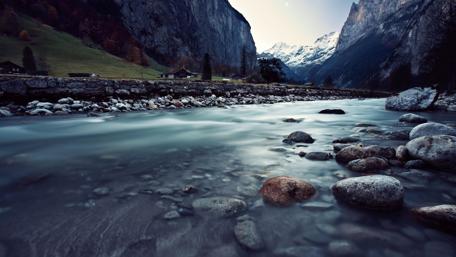 Serene River Landscape Amidst Majestic Mountains wallpaper