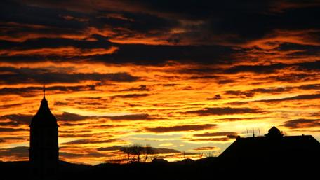 Breathtaking Sunrise Over Silhouetted Landscape wallpaper