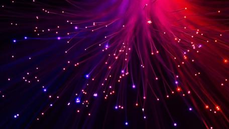 Radiant Light Explosion in Deep Red and Purple wallpaper