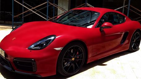 Sleek Red Porsche in Modern Setting wallpaper