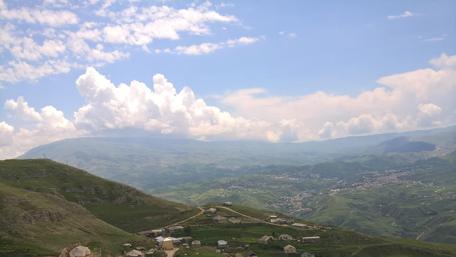 Breathtaking Mountain Panorama with Clouds and Villages wallpaper