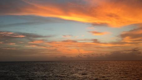 Serene Caribbean Sunset Over Tranquil Waters wallpaper