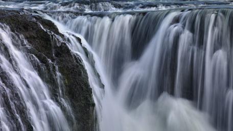 Majestic Waterfall Cascading Over Rocks wallpaper