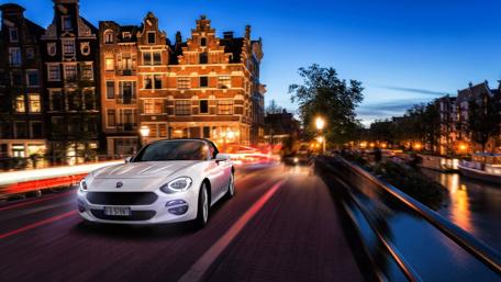 Dreamy Fiat Spider Cruising Amsterdam Streets wallpaper