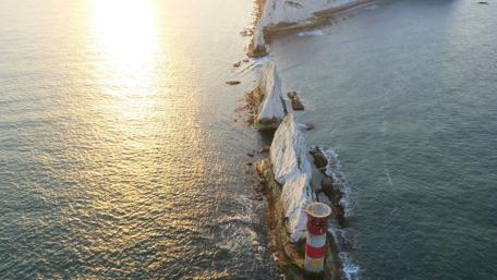 Serene Lighthouse at Sunrise over the Isle of Wight wallpaper