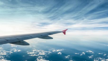Wings Above the Clouds in Blue Sky wallpaper