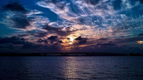 Dramatic Sunset Over Bridge and Water wallpaper
