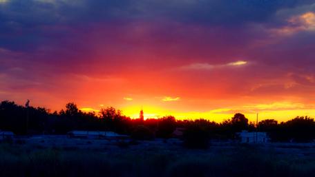 Vibrant Sunset Over a Serene Landscape wallpaper