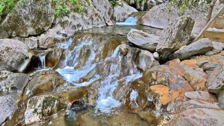 Tranquil Mountain Waterfall in Nature's Embrace wallpaper