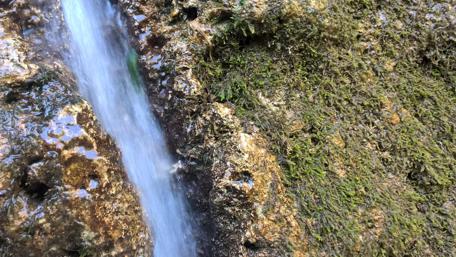 Waterfall surrounded by rocks wallpaper