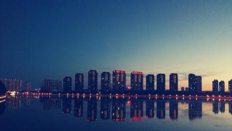Reflection of city lights in water wallpaper