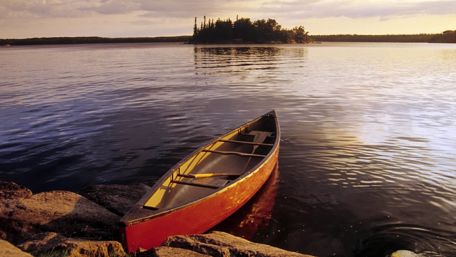 Serene Evening at the Lake with a Canoe wallpaper