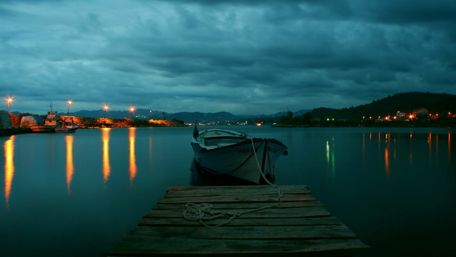 Boat on the calm water in the twilight wallpaper