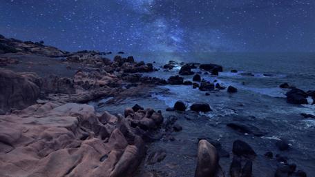 Rocky coast side with milky way wallpaper